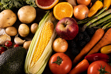 Full frame shot of corn with various fruits and vegetables on table