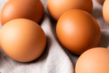 High angle close-up of fresh brown eggs on gray napkin