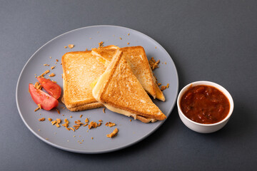 High angle view of fresh cheese toast sandwich served with tomato slices and dip on blue background