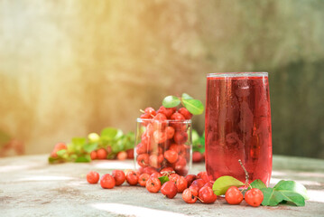 Glass of sour cherry juice with fresh red cherries, Cherry juice, on wood background, red drink, High vitamin C and antioxidant fruits.