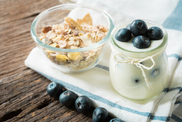 yogurt with fresh blueberry on a wooden background. healthy cereal morning breakfast,oat