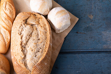 Close-up of various breads on brown wax paper at table