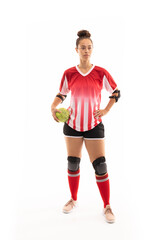 Full length of biracial young female player with handball standing against white background