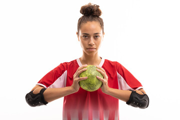 Portrait of confident biracial young female player with handball against white background