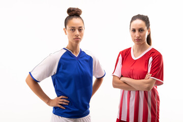 Portrait of biracial and caucasian young female players standing with arms crossed and hands on hip