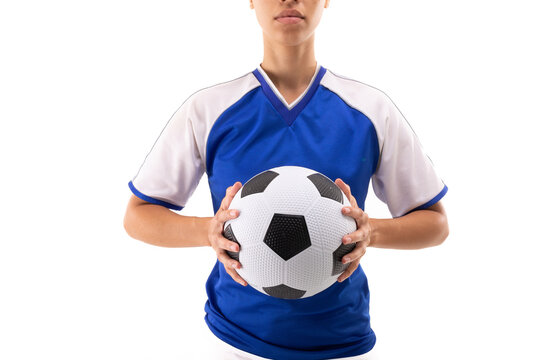 Midsection of biracial young female player in blue jersey with soccer ball against white background