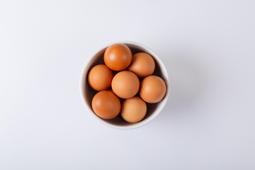 Directly above shot of brown eggs in bowl on table