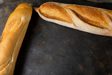 Close-up of baguettes on brown table