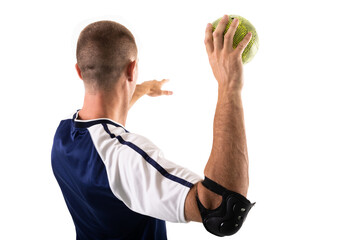 Young male caucasian athlete wearing elbow guard playing handball on white background