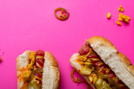 Overhead Close-up Of Hot Dogs On Pink Background