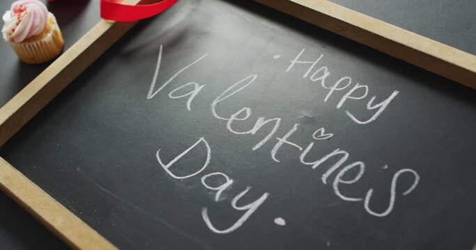 Happy valentine's day text and cupcakes on gray background