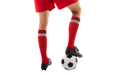 Low section of young male caucasian athlete stepping on soccer ball against white background