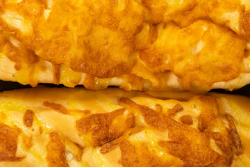Homemade Cheesy Bread over wooden background.
