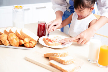 mother and daughter eat healthy breakfast at home happy family in the kitchen mother and daughter having breakfast