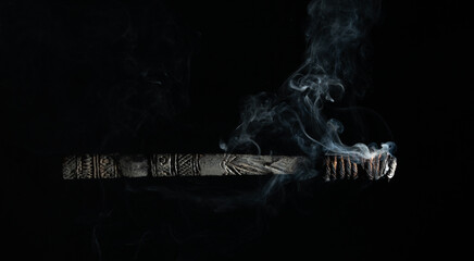 smoking torch isolated on black background