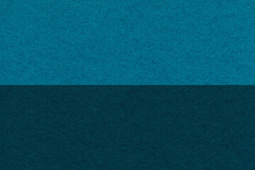 Fototapeta premium Texture of craft navy blue and turquoise paper background, half two colors, macro. Vintage dark cerulean cardboard.