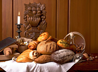 Bakery products of various types. Wicker basket with different types of bread on a wooden table.