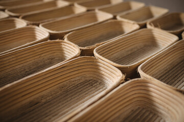 Full frame shot of wicker bread baskets arranged side by side in bakery