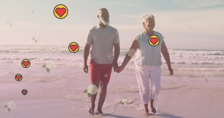 Animation of falling hearts over african american senior couple on the beach