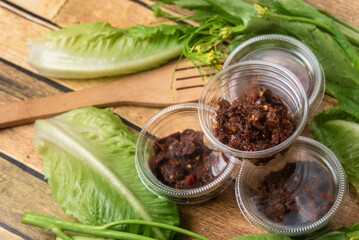 Asian street food chili paste, on the wooden floor, chili paste