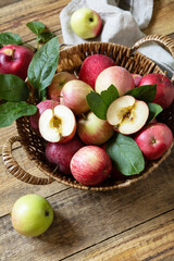 Fall harvest background. Organic fruits. Farmer's market. Basket of ripe apples on a rustic wooden table. Copy space.