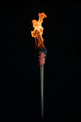 ancient wooden torch isolated on black background - obrazy, fototapety, plakaty