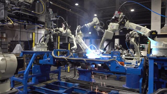 Automatic welding robotic arm, welding car parts with automatic robot, using robots to weld car parts.