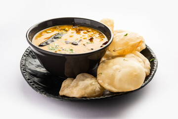 Luchi Cholar Dal or Fried bread made of flour served along with curried Chana or Bengal gram