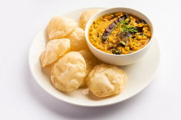 Luchi Cholar Dal or Fried bread made of flour served along with curried Chana or Bengal gram