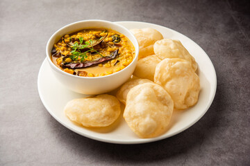 Luchi Cholar Dal or Fried bread made of flour served along with curried Chana or Bengal gram