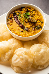Luchi Cholar Dal or Fried bread made of flour served along with curried Chana or Bengal gram