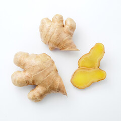 Fresh ginger with slice on white paper background , top view , flat lay.