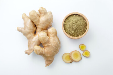 Fresh ginger slice with ginger powder in wooden bowl on white paper background , top view , flat lay.