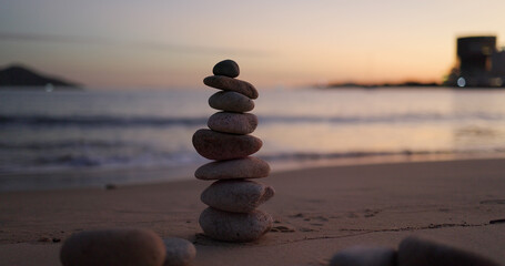 Zen stones on the beach at sunset time