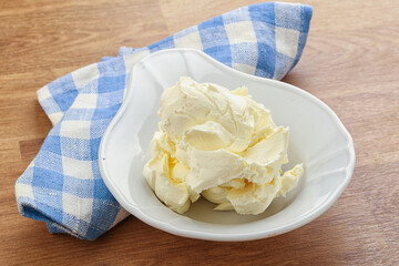 Italian soft mascarpone cheese in the bowl