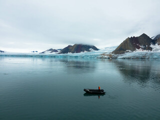 Spectacular view of the glacier with icebergs and Zodiac tourist boats in the foreground....