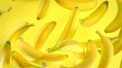 Super Slow Motion Shot of Fresh Bananas on Yellow Background Flying Towards Camera at 1000fps. - Powered by Adobe