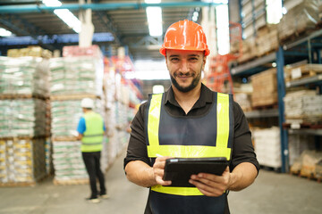 Professional manager man employee using tablet check stock working at warehouse. Worker wearing...