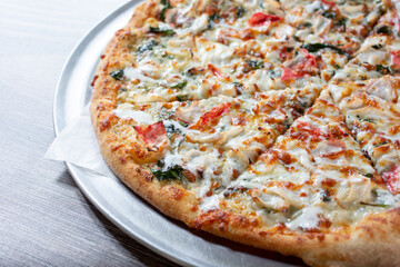 A view of a crab and spinach pizza.