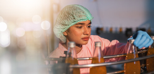 Manufacturing plant, industrial production line working person beverage factory Commercial work, equipment bottles, professional engineers supervise the production line. and factory technology Quality