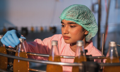 Manufacturing plant, industrial production line working person beverage factory Commercial work, equipment bottles, professional engineers supervise the production line. and factory technology Quality