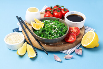 Concept of Japanese cuisine on blue background, Chuka salad