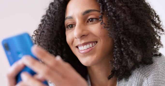 Relax girl with phone reading or watch funny video, comic or meme and happy with smile on her face close up. Black woman looking at social media contact text message from friends on mobile smartphone