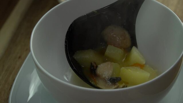 Adding Mushroom soup in a white bowl