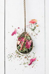 Herbal tea. Detox. Dry tea on a vintage spoon and a white background. Top view. Flatlay