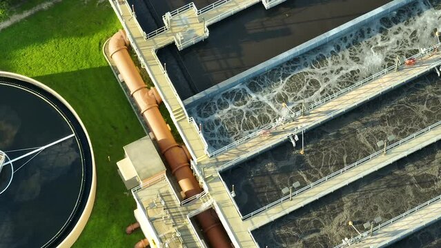 Aerial view of modern water cleaning facility at urban wastewater treatment plant. Purification process of removing undesirable chemicals, suspended solids and gases from contaminated liquid