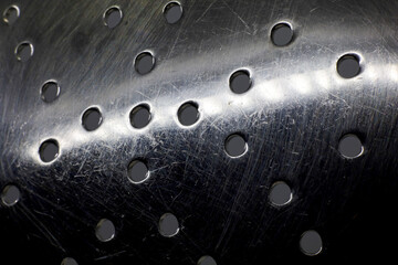 extreme close-up perforated metal surface texture