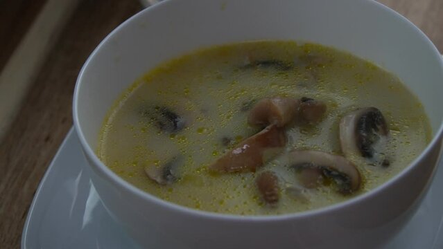 Adding Mushroom soup in a white bowl