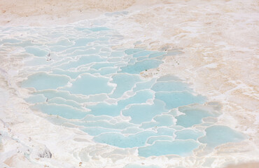 Emerald water in white limestone rock.