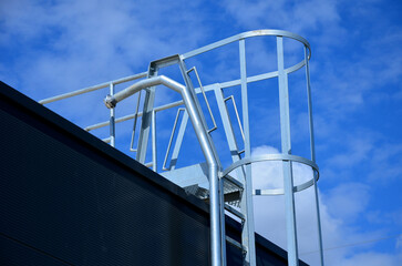 the fire ladder leading to the roof of the hall is secured by a grille in the lower part of the...